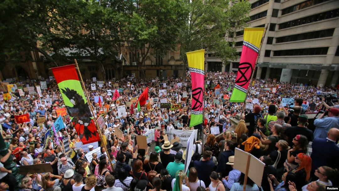 Protesters hold placards during a climate change rally in Sydney, Jan. 10, 2020.