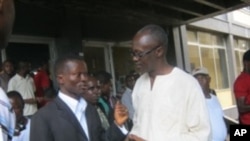 Press Union of Liberia president Peter Quaqua (left) with journalist Aaron Kollie