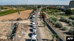 This aerial view shows humanitarian aid trucks arriving from Egypt after having crossed through the Rafah border crossing arriving at a storage facility in Khan Yunis in the southern Gaza Strip on Oct. 21, 2023.