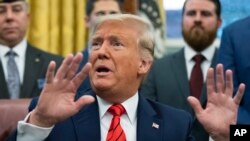 President Donald Trump speaks to reporters during the Supporting Veterans in STEM Careers Act signing ceremony in the Oval Office at the White House, Feb. 11, 2020, in Washington.