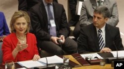 Austrian Foreign Minister Michael Spindelegger, right, listens as U.S Secretary of State Hillary Rodham Clinton addresses a Security Council meeting Tuesday, Oct. 26, 2010 at United Nations headquarters. (AP Photo/Mary Altaffer)