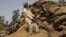 A laborer pulls at a sack of rotting wheat grain to try to salvage any that was still edible, at an open storage area in Khamanon village, some 215 kilometers (133 miles) from Amritsar, India. 