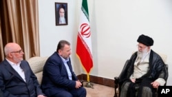 FILE - In this photo released by an official website of the office of the Iranian supreme leader, Supreme Leader Ayatollah Ali Khamenei, right, meets Hamas deputy chief, Saleh al-Arouri, second right, and the Hamas delegation, in Tehran, Iran, Monday, July 22, 2019.