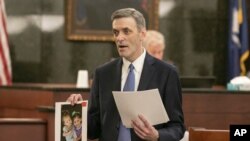 Solicitor Rick Hubbard delivers closing arguments, showing pictures of the Jones children during the sentencing phase of the trial of Timothy Jones Jr. in Lexington, S.C., on June 13, 2019. Jones, Jr. was found guilty of murdering his 5 children.