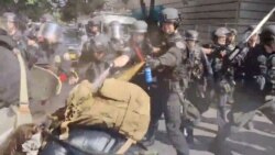 Police use pepper spray against protesters in Portland, Oregon, May 31, 2020, in this still image taken from video obtained by Reuters.