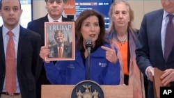 This image from video provided by Office of the New York Governor shows New York Gov. Kathy Hochul holding a mock magazine cover during an event about congestion pricing at New York's Grand Central Terminal, Feb. 19, 2025.