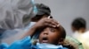 A young girl reacts as a medical worker takes a swab during mass tasting in an effort to fight against the spread of the coronavirus disease (COVID-19) in the Kawangware neighborhood of Nairobi, Kenya, May 2, 2020.
