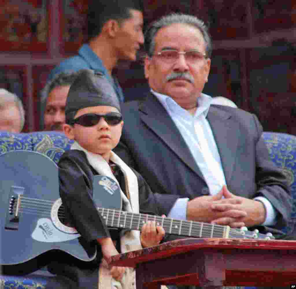 Young guitarist seated with Maoist leader Prachanda