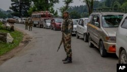 An Indian border security force soldier stands guard at a temporary checkpoint near a pilgrim base camp near Pahalgam, about 100 Kilometers south of Srinagar, Indian controlled Kashmir, July 11, 2017.