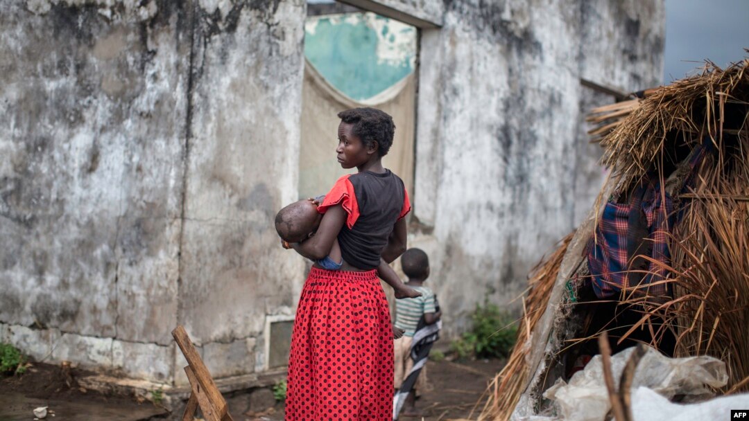 A woman holds her child at a makeshift camp for internally displaced persons (IDPs) among old abandoned buildings in Kalemie, Tanganyika province, Democratic Republic of the Congo, Sept. 18, 2017.