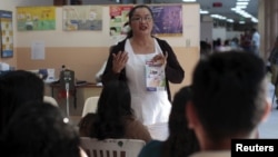 Patients participate in a Zika prevention talk as they wait to be attended to at the Women's National Hospital in San Salvador, El Salvador, Jan. 29, 2016. 