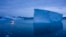 FILE: A boat navigates at night next to large icebergs in eastern Greenland on Aug. 15, 2019. Zombie ice from the massive Greenland ice sheet will eventually raise global sea level by at least 27 centimeters on its own, according to a study released Monday, Aug. 29, 2022.