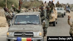 Chadian soldiers escorting a group of journalists ride on trucks and pickups in the Nigerian city of Damasak, Nigeria, March 18, 2015. 