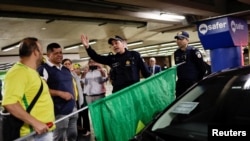 Members of the police forces talk with Bolsonaro supporters while reinforcing security at the airport for the arrival of the former president of Brazil, Jair Bolsonaro in Brasilia, Brazil, March 30, 2023.