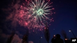 FILE - Visitors use their smartphones to take pictures of fireworks to celebrate the first full moon of the Lunar New Year, in Seoul, South Korea, Feb. 4, 2023.