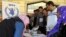 Syrian refugees lined up at a distribution center to receive a new debit bank card through which all aid agencies transfer their aid, at Bar Elias town in Lebanon's Bekaa valley, Oct. 25, 2016. 