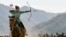 In this photo taken on September 6, 2018, a women shoots an arrow in a competition during the Third Nomad Games, in Cholpon-Ata, 250 kilometers from Bishkek, Kyrgyzstan. (AP Photo)