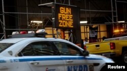 FILE PHOTO: A sign similar to what is to be placed in the Times Square "gun free zone" is displayed regarding new gun laws in New York