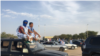 Supporters of opposition candidate Mohamed Ould Mouloud sit on their car for a better view of his final campaign rally (E. Sarai/VOA) 