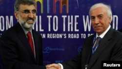 FILE - Kurdistan Regional Government Natural Resources Minister Ashti Hawrami, right, shakes hands with Turkey's Energy Minister Taner Yildiz, Irbil, Iraq, May 2012.