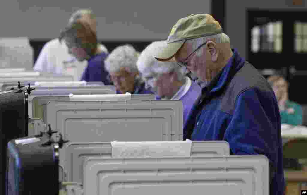 Voters cast their ballot at a polling place during a primary election in Frederick, Maryland, April 3, 2012. (AP)