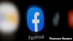FILE PHOTO: A Facebook logo is displayed on a smartphone in this illustration