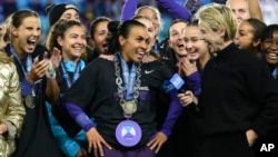 FILE - Orlando Pride forward Marta, center, is interviewed after their NWSL championship win over the Washington Spirit at CPKC Stadium in Kansas City, Missouri, Nov. 23, 2024.