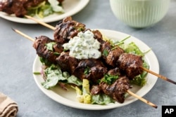 FILE - A recipe for lamb kebabs appears in New York. Kebabs can be made from many types of meat, seafood, fish, poultry or vegetables, or a combination thereof. (Cheyenne Cohen via AP)