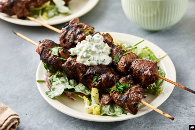 FILE - A recipe for lamb kebabs appears in New York. Kebabs can be made from many types of meat, seafood, fish, poultry or vegetables, or a combination thereof. (Cheyenne Cohen via AP)