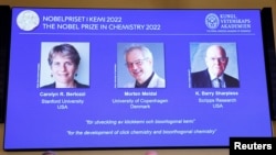 Screen shows winners Carolyn R. Bertozzi (U.S), Morten Meldal (Denmark) and K. Barry Sharpless (U.S.) of the 2022 Nobel Prize in Chemistry. (TT News Agency/Christine Olsson via REUTERS)