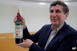 FILE - Philippe Darriet, President, ISVV Institute for wine and vine research and Head oenologist holds a bottle of Petrus red wine that spent a year orbiting the world in the International Space Station in Villenave-d'Ornon, southwestern France, March 1, 2021