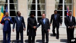 French President Francois Hollande, third right, shakes hands with Nigeria President Goodluck Jonathan, third left, as others, from left, Niger's President Mahamadou Issoufou, Chad's President Idriss Debi, Cameroon President Paul Biya, Benin president Tho
