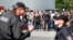 People stand outside during a visit of German Chancellor Angela Merkel to an asylum seekers accomodation facility in the eastern German town of Heidenau near Dresden, August 26, 2015 where last week more than 30 police were injured in clashes, when a mob 
