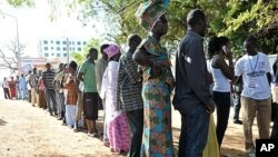 People wait to vote outside a polling station in Serrekunda, southwest the capital Banjul, during the presidential elections. Gambians voted in polls, which some observers said were skewed in favor of incumbent Yahya Jammeh, who heaped scorn on criticism