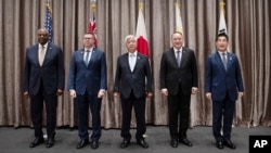 Defense ministers Lloyd Austin of the U.S., Pat Conroy of Australia, Gen Nakatani of Japan, Gilberto C. Teodoro Jr. of the Philippines and Kim Yong Hyun of South Korea pose during an ASEAN meeting in Vientiane, Laos, Nov. 21, 2024. (South Korean Defense Ministry via AP)