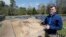 Historic Jamestown senior staff archaeologist David Givens gestures at the dig site of the Angelo slave house in Jamestown, Va., April 10, 2018.