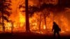 Seorang petugas damkar melewati kobaran api dari kebakaran hutan "Dixie Fire" di Plumas County, California (24/7). 