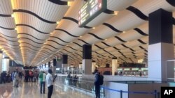 Passengers wait in the departure hall of the new Blaise Diagne International Airport in Diass, Senegal, Dec. 7, 2017.