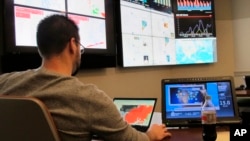 Joe Balog, a workforce management director at Travelers, examines weather, social media and other data from recent natural disasters inside the company's catastrophe response command center in Windsor, Connecticut, Nov. 16, 2018.