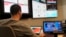 Joe Balog, a workforce management director at Travelers, examines weather, social media and other data from recent natural disasters inside the company's catastrophe response command center in Windsor, Connecticut, Nov. 16, 2018.