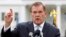 FILE - Former Secretary of Homeland Security Tom Ridge speaks to a crowd of hundreds protesting in front of the White House in Washington, Oct. 22, 2011.