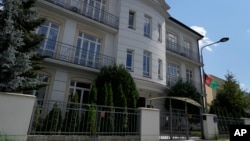 A flag hangs outside the Afghanistan Embassy in Warsaw, Poland, July 30, 2024. The Taliban is disavowing many Afghan diplomatic missions overseas, saying it will not honor passports, visas and other documents issued by diplomats associated with the nation's former administration.