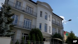 A flag hangs outside the Afghan Embassy in Warsaw, Poland, on July 30, 2024. While the Taliban has disavowed many Afghan diplomatic missions, Afghan diplomats say they will continue to provide consular services.