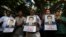 Indian journalists hold candles and photographs of Akshay Singh, who died July 4 under mysterious circumstances while reporting on corruption allegations in Madhya Pradesh, during a memorial meeting in Bangalore, India, July 6, 2015. 
