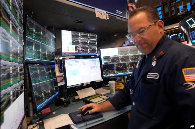 Specialist Anthony Matesic works at his post on the floor of the New York Stock Exchange, March 11, 2025.