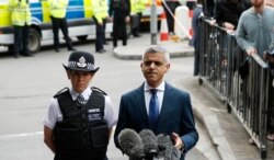 FILE - Mayor of London Sadiq Khan, right, speaks during a media conference at London Bridge in London, June 5, 2017.