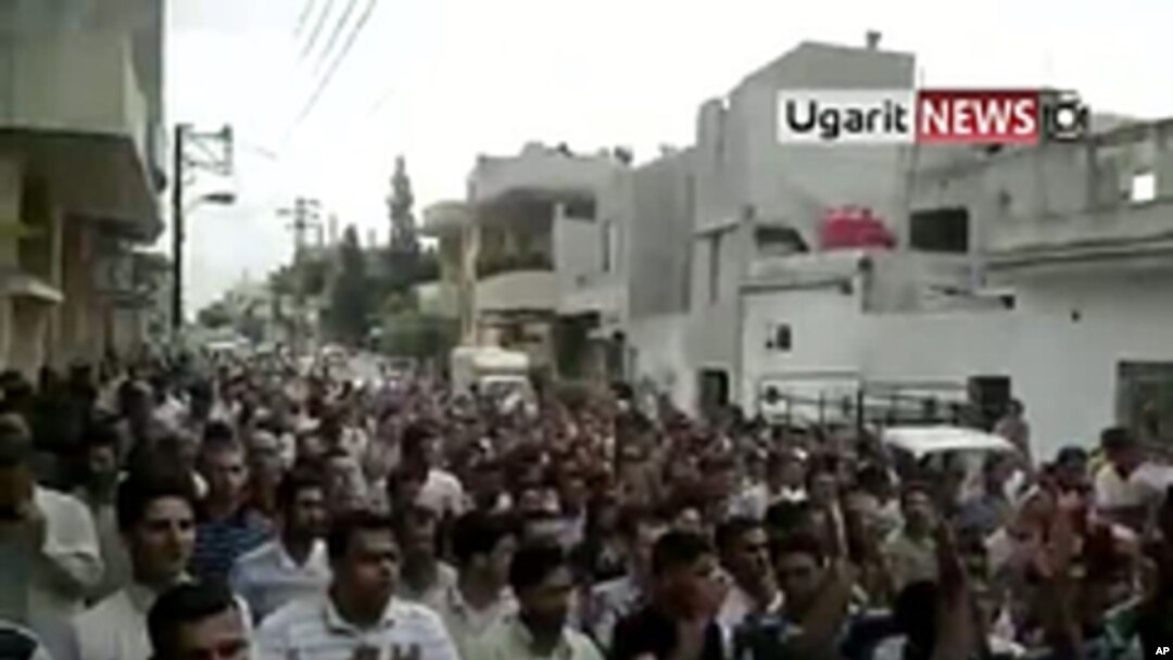 An image taken from footage uploaded on YouTube shows Syrian anti-government protesters flooding the streets of the central city of Hama, July 8, 2011