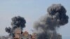 FILE - Smoke billows from residential buildings following Israeli airstrikes in Gaza City on October 7, 2023. (Photo by MAHMUD HAMS / AFP)