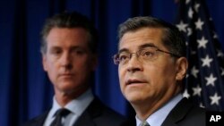 California AG Xavier Becerra, right, flanked by Gov. Gavin Newsom, discusses the Trump administration's pledge to revoke California's authority to set vehicle emissions standards, Sept. 18, 2019.