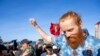 FILE—British runner Russ Cook celebrates with supporters after arriving to the finish line in Ras Angela, the most northern point of the African continent, in Tunis, Tunisia, April 7, 2024. 